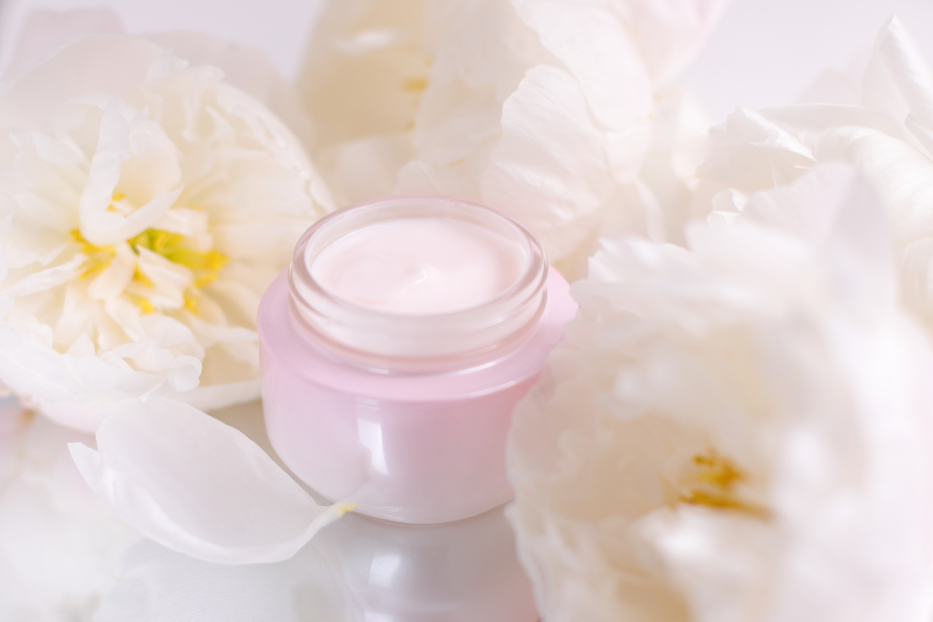 Cream cosmetic container with peony flowers, pink face lotion